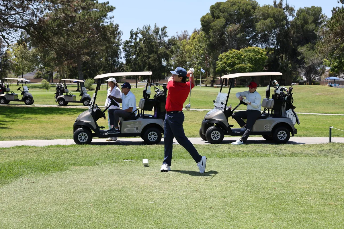 A golfer tees off at the 30th Annual Benefit Golf Tournament
